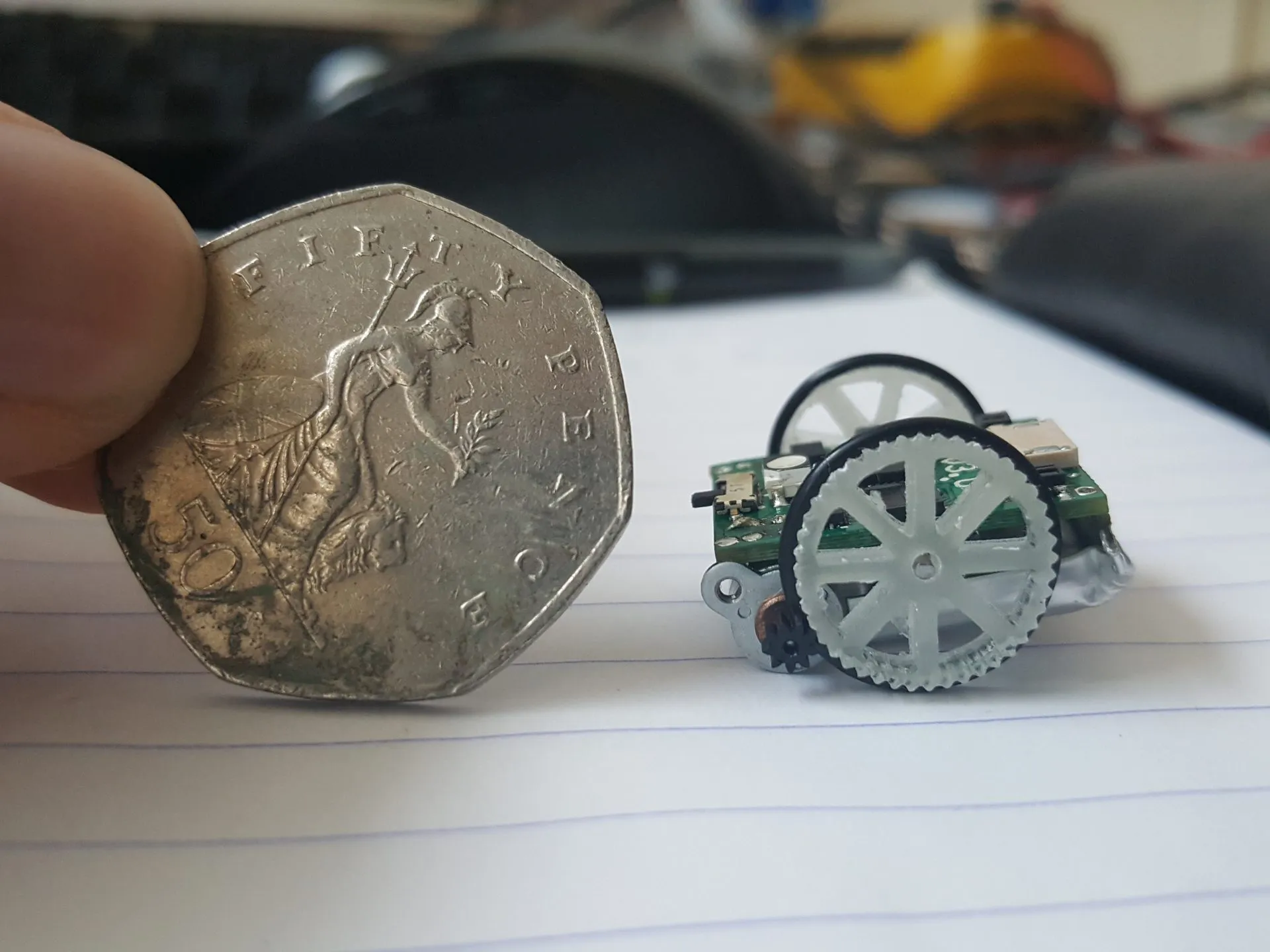Micro robot next to a coin for scale